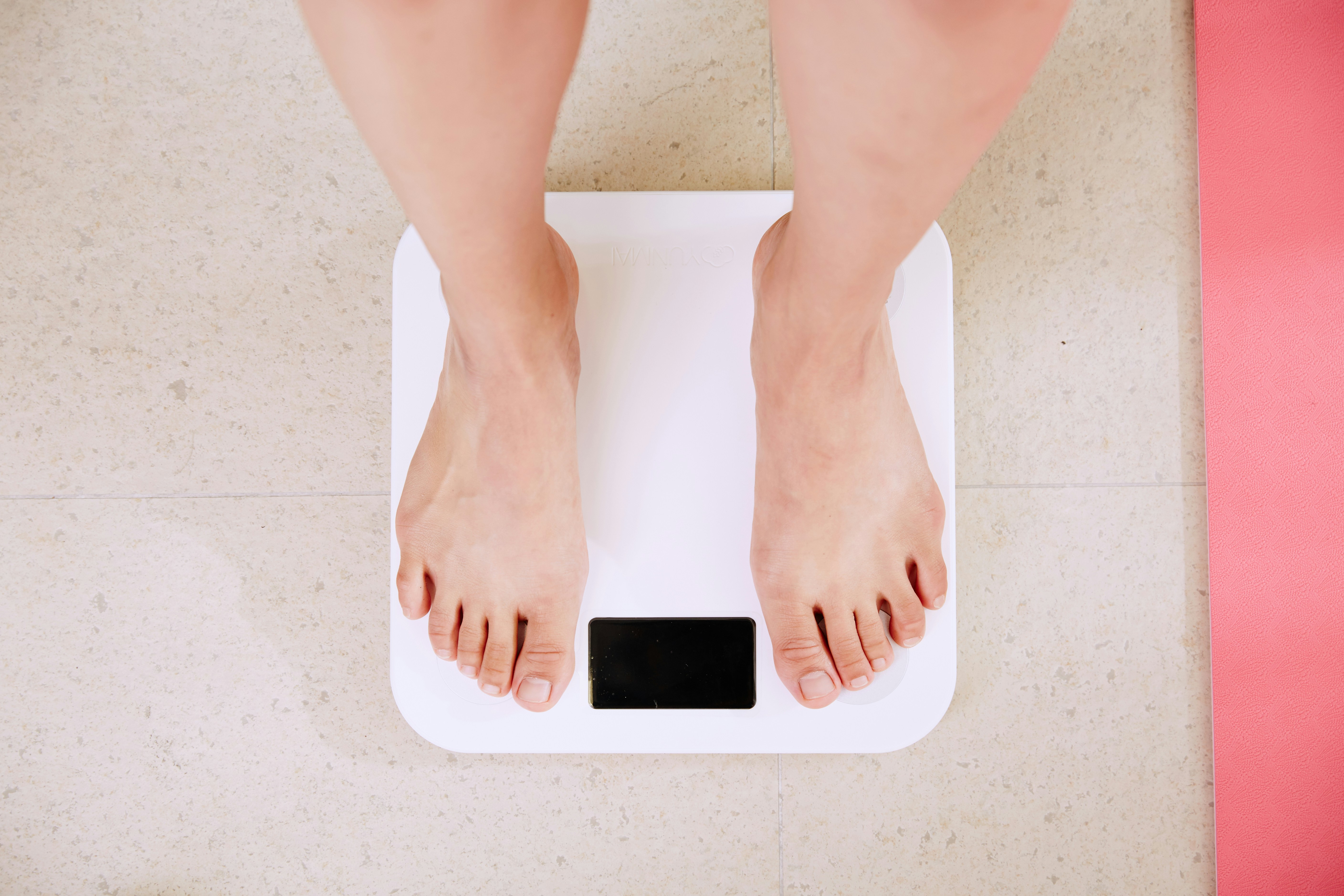 woman standing on a weigh scale