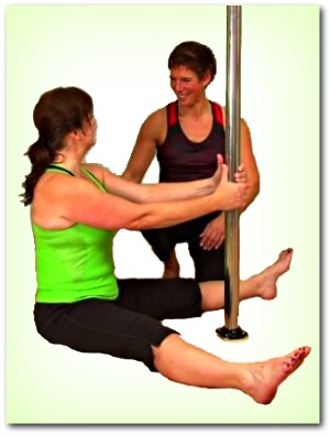 pole dance teacher helping student